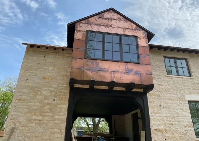 Copper metal panel facade on a stone building for Skylight Installation in Ceres